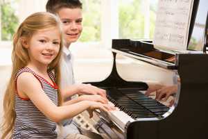 Children playing piano | CB Moving and Storage