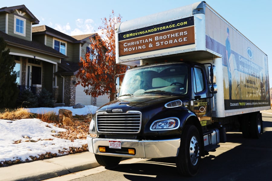 CB Moving and Storage truck, outside a residential house in Colorado
