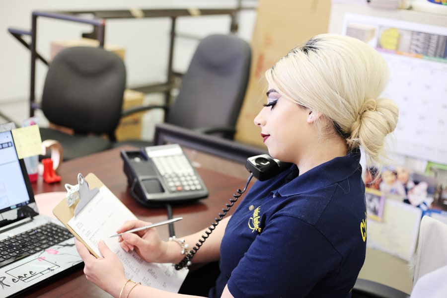 A CB Moving and Storage team member preparing moving day checklist in the office